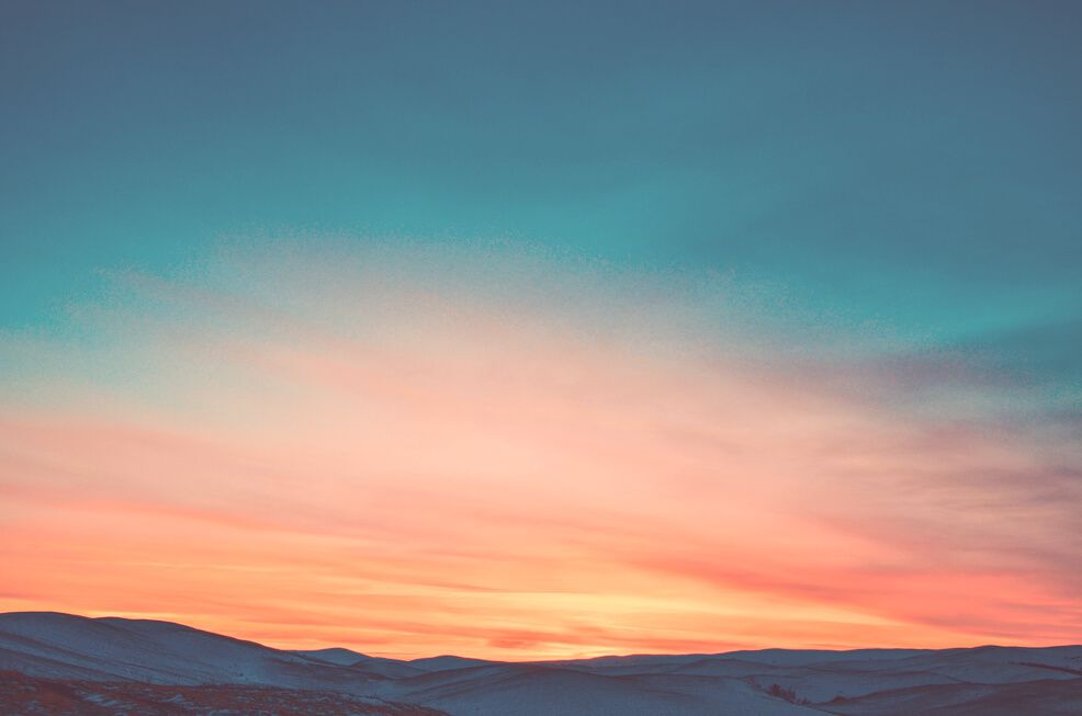 Sunset over Snow Covered Mountains